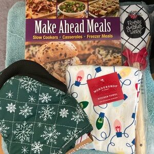 New cookbook, oven mitt, kitchen towel and spatula